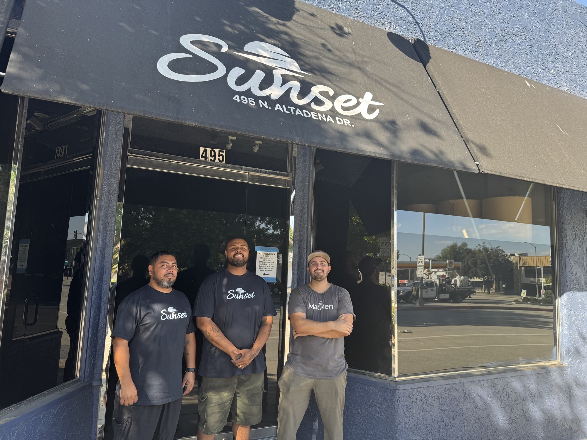 The Sunset Production Supplies office team — Ricardo, Damion and Michael — outside the storefront