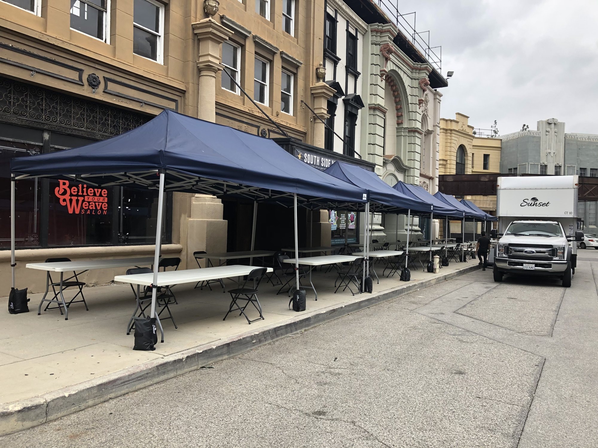 Navy Sunset lunch tents with tables and chairs along a studio backlot street