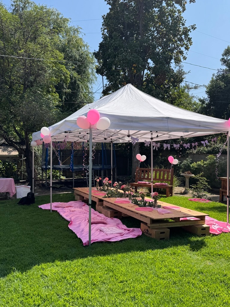 White Sunset tent over a garden party table with pink balloon decorations