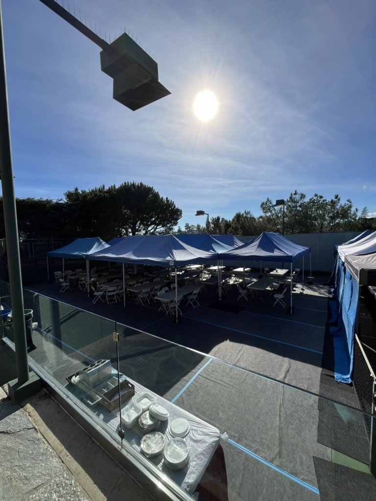 Sunset navy lunch tents on a rooftop with tables and chairs