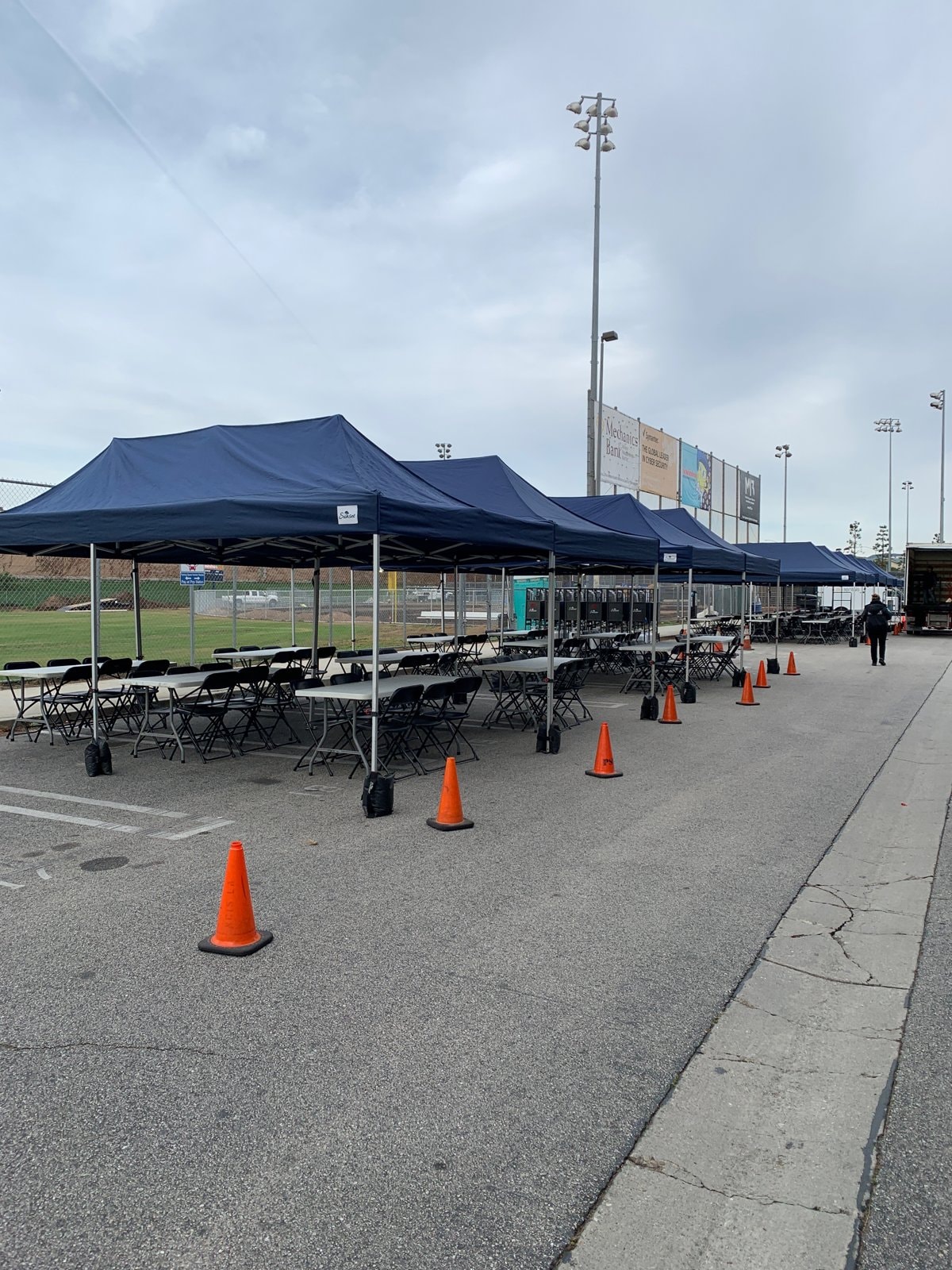 Full-scale crew village with navy tents at a sports facility